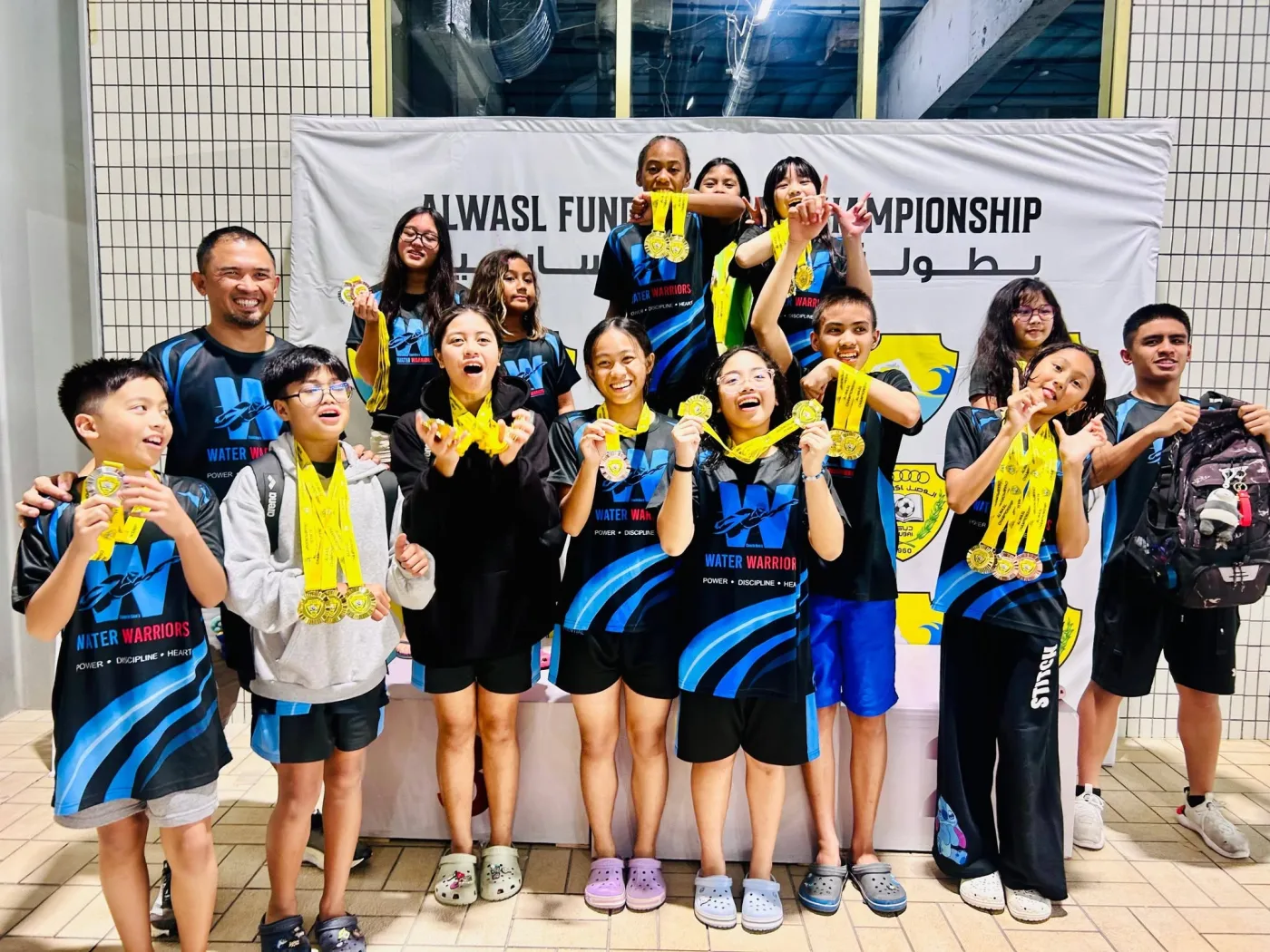 Water Warriors teammates celebrating together with their Al Wasl Championship medals
