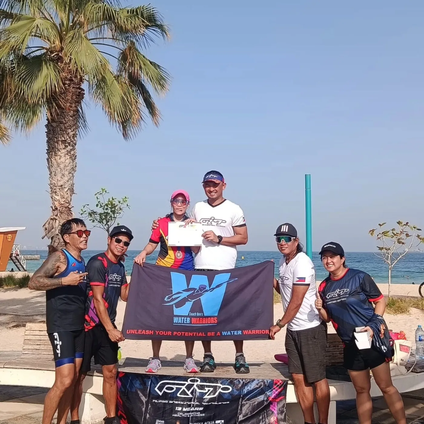 FiT athletes and supporters holding a Water Warriors banner at an award celebration